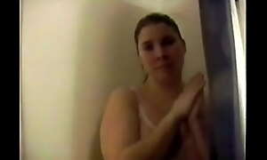 Busty Brunette with big natural tits strips in the shower and gets wet